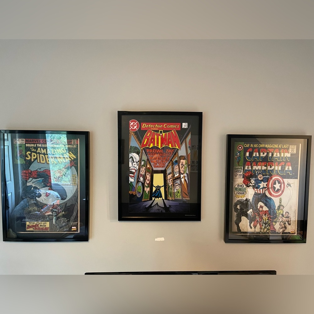 3 pre-owned super hero pictures in black frames.  All 3 19”x25”.